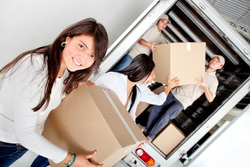 Local team handling sofa and bed removal in a Battersea apartment building