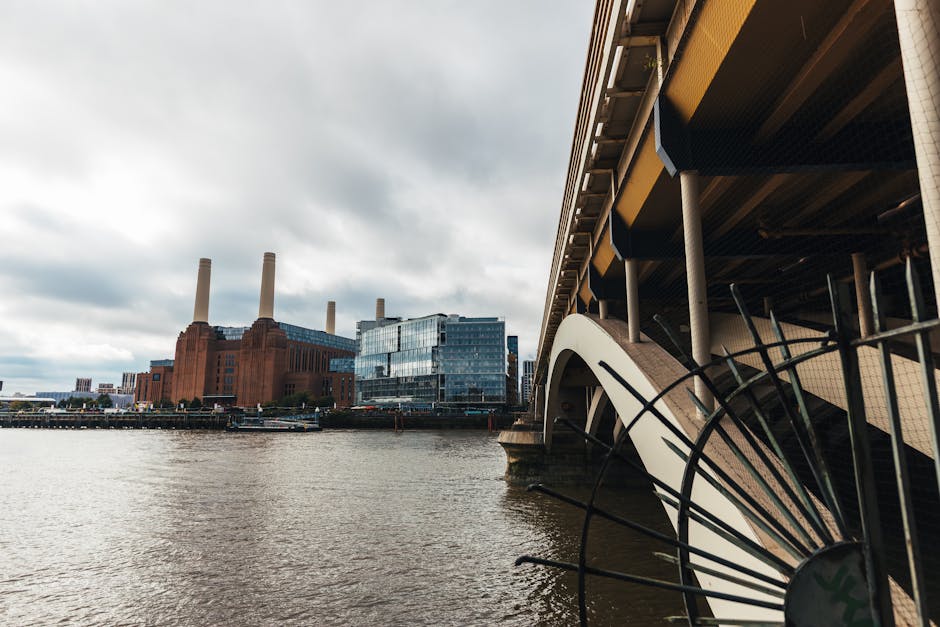 The image shows a view of the River Thames in Battersea, with the industrial Battersea Power Station featuring its distinctive four chimneys visible in the background. On the right side, part of a mod