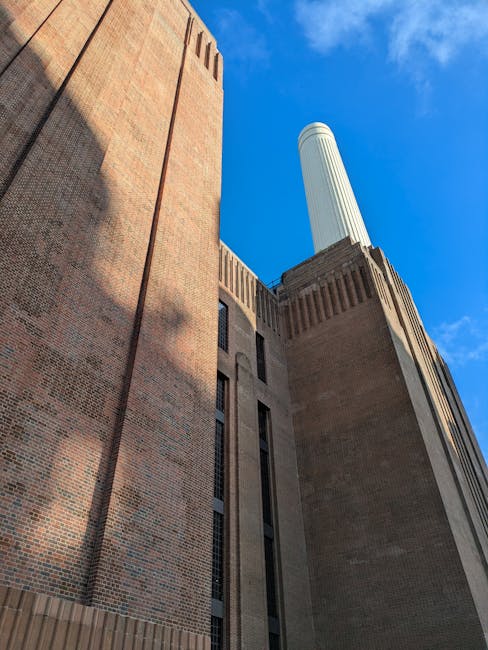 The image shows a view of the River Thames in Battersea, with the industrial Battersea Power Station featuring its distinctive four chimneys visible in the background. On the right side, part of a mod